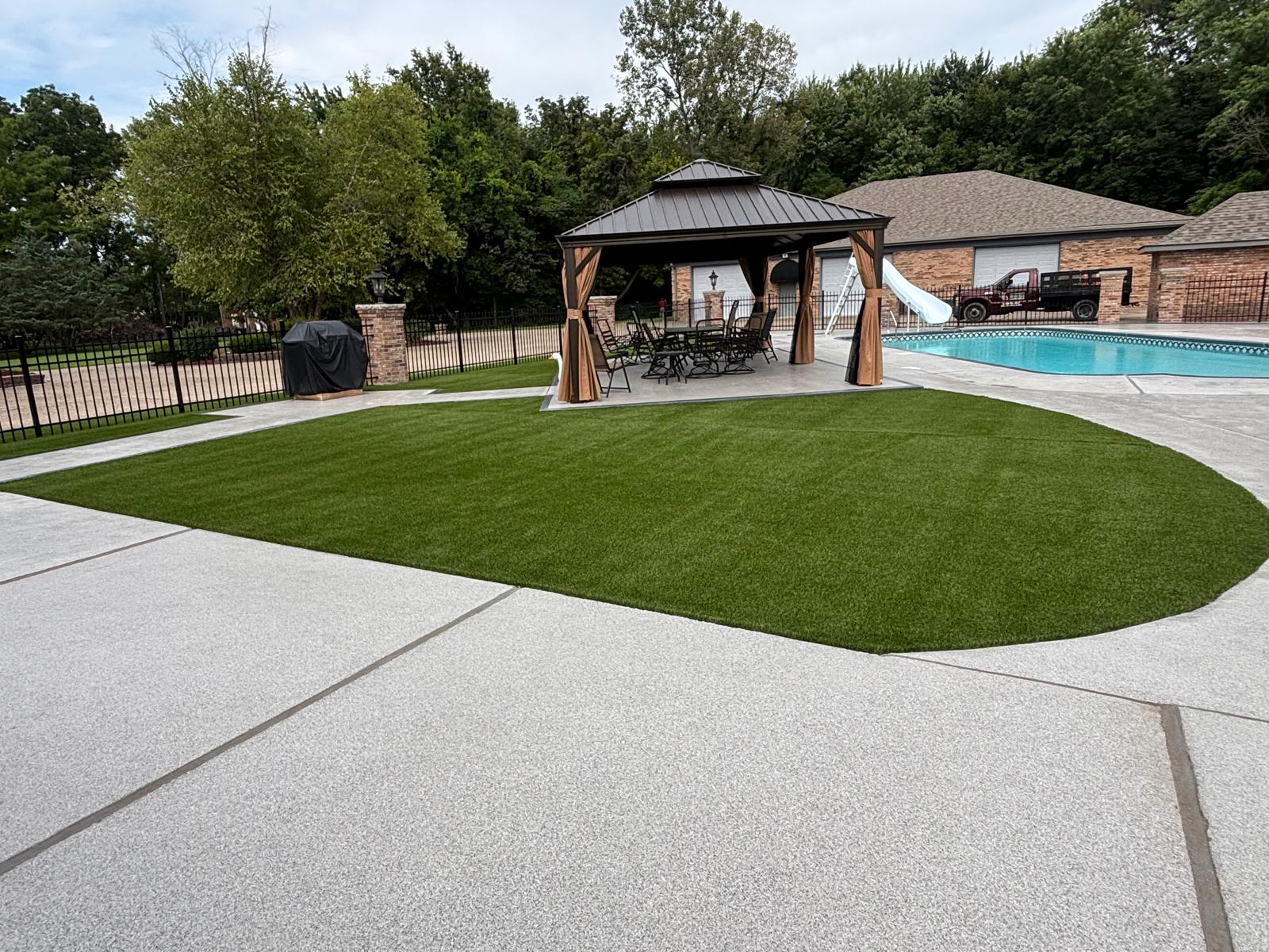 Completed synthetic lawn beside outdoor living space